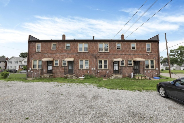 635-641 Racine Ave, Columbus, OH 43204 - view of property featuring a chimney, brick siding, and entry steps