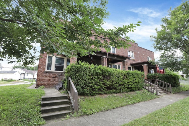 635-641 Racine Ave, Columbus, OH 43204 - obstructed view of property featuring brick siding and a front lawn