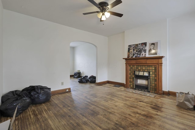 635-641 Racine Ave, Columbus, OH 43204 - unfurnished living room with arched walkways, wood finished floors, a ceiling fan, and a tiled fireplace
