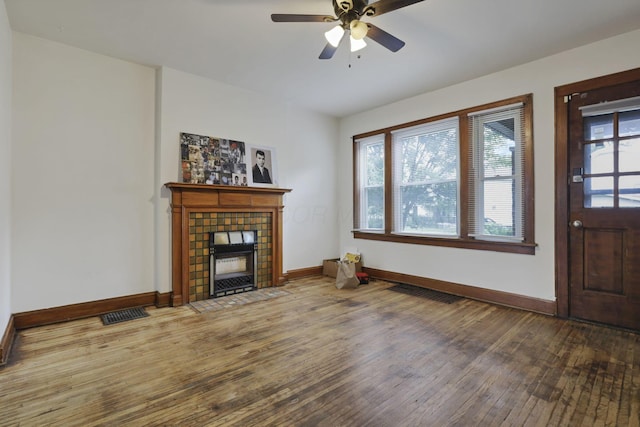 635-641 Racine Ave, Columbus, OH 43204 - unfurnished living room with wood finished floors, a tile fireplace, and a ceiling fan