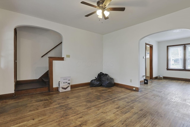 635-641 Racine Ave, Columbus, OH 43204 - spare room featuring ceiling fan, hardwood / wood-style flooring, arched walkways, and stairway