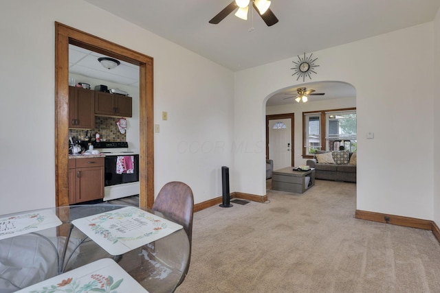 635-641 Racine Ave, Columbus, OH 43204 - dining space featuring arched walkways, a ceiling fan, light carpet, and bar