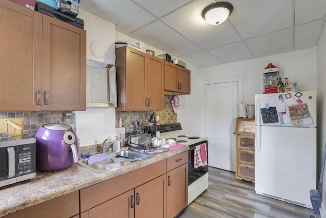 635-641 Racine Ave, Columbus, OH 43204 - kitchen featuring white appliances, a paneled ceiling, light countertops, tasteful backsplash, and light wood-style floors