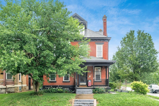 572 Linwood Ave, Columbus, OH 43205 - view of front of home featuring brick siding, a front lawn, a porch, a chimney, and a shingled roof