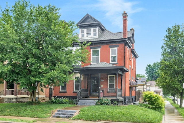 572 Linwood Ave, Columbus, OH 43205 - american foursquare style home with covered porch, a chimney, and brick siding