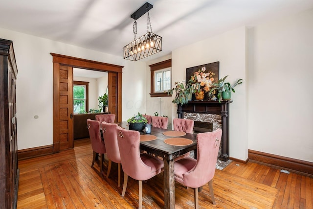 572 Linwood Ave, Columbus, OH 43205 - dining room with light wood finished floors, healthy amount of natural light, and a chandelier