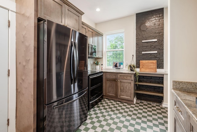 572 Linwood Ave, Columbus, OH 43205 - kitchen with appliances with stainless steel finishes, tile patterned floors, light stone counters, and recessed lighting