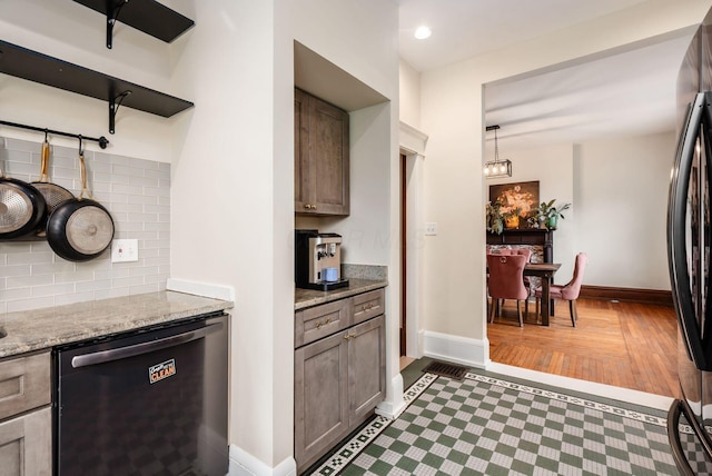 572 Linwood Ave, Columbus, OH 43205 - kitchen featuring black dishwasher, fridge, backsplash, light stone counters, and wood finished floors