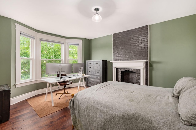 572 Linwood Ave, Columbus, OH 43205 - bedroom featuring dark wood-style flooring, multiple windows, a fireplace, and a desk
