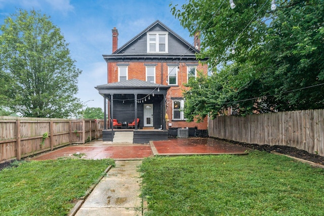 572 Linwood Ave, Columbus, OH 43205 - back of property featuring a chimney, brick siding, a fenced backyard, and a patio area