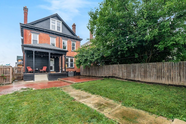 572 Linwood Ave, Columbus, OH 43205 - back of house with a patio area, a chimney, brick siding, and a fenced backyard