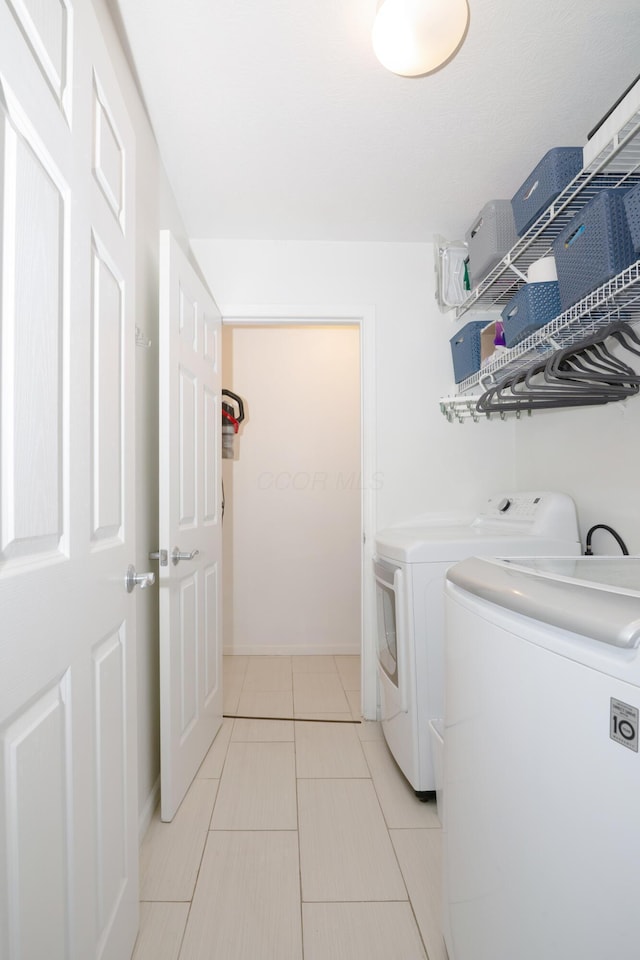 5928 Treven Way, Westerville, OH 43081 - laundry room with washer and clothes dryer and light tile patterned floors