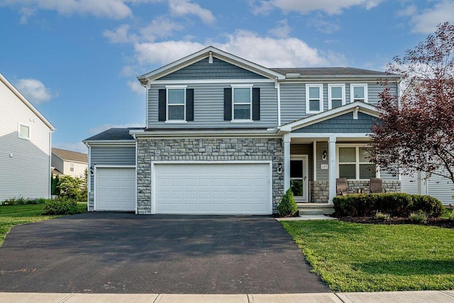123 Schellinger St, Delaware, OH 43015 - view of front facade with covered porch, asphalt driveway, stone siding, and a front lawn