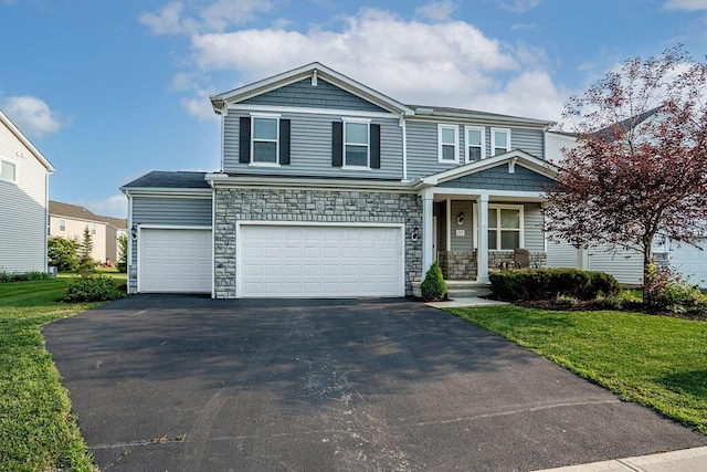 123 Schellinger St, Delaware, OH 43015 - view of front of home featuring covered porch, driveway, a front yard, and stone siding