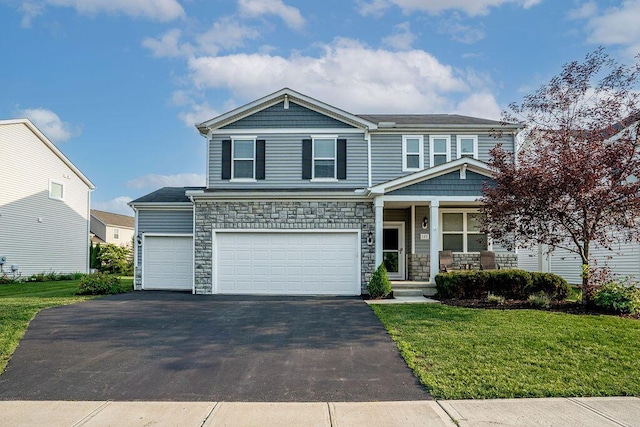 123 Schellinger St, Delaware, OH 43015 - craftsman-style home featuring a porch, driveway, a front lawn, and stone siding