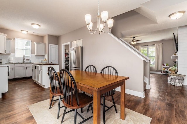 2020 Edison St, Newark, OH 43055 - dining space featuring a ceiling fan, a chandelier, washer / clothes dryer, and dark wood-type flooring