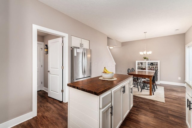 2020 Edison St, Newark, OH 43055 - kitchen featuring freestanding refrigerator, butcher block countertops, dark wood finished floors, white cabinetry, and a chandelier