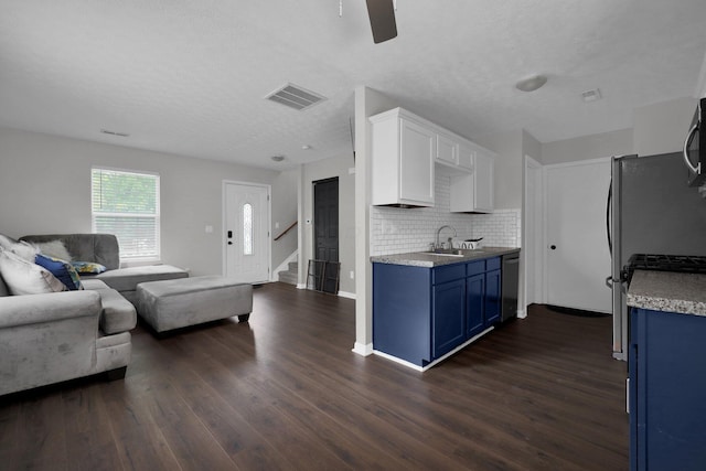 4686 Willowburn Dr, Columbus, OH 43207 - kitchen with blue cabinets, open floor plan, dark wood-style flooring, and a textured ceiling