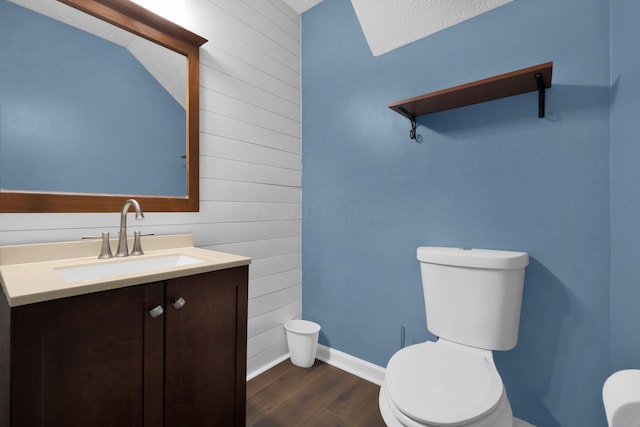 4686 Willowburn Dr, Columbus, OH 43207 - half bath featuring wood walls, vanity, and wood finished floors