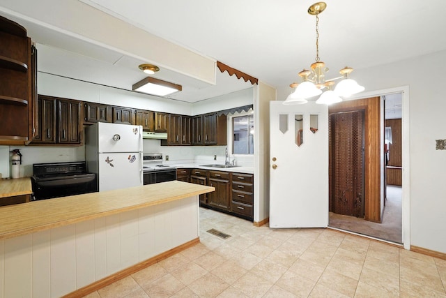 814 Gilmore Dr, Reynoldsburg, OH 43068 - kitchen featuring range with electric cooktop, freestanding refrigerator, under cabinet range hood, dark brown cabinets, and a chandelier