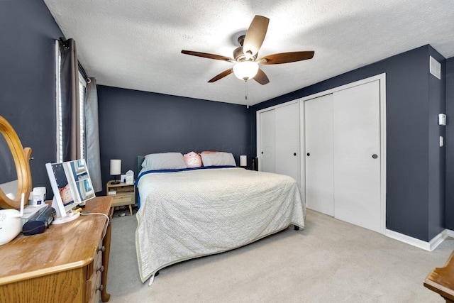 8711 Blessing Dr, Powell, OH 43065 - bedroom featuring carpet floors, a textured ceiling, multiple closets, and ceiling fan