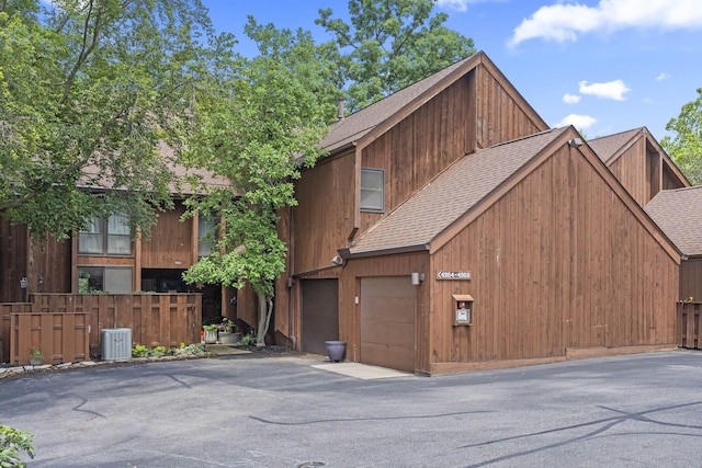 4968 Wintersong Ln Unit 10, Westerville, OH 43081 - view of front of property featuring roof with shingles, a garage, and asphalt driveway