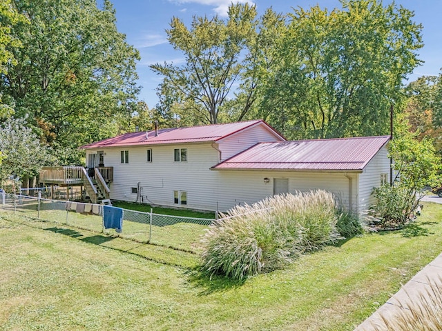 4250 Herr Fieldhouse Rd, Southington, OH 44470 - view of side of property featuring a wooden deck, a fenced backyard, and a metal roof