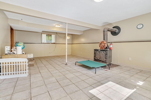 4250 Herr Fieldhouse Rd, Southington, OH 44470 - below grade area featuring tile patterned flooring and a wood stove