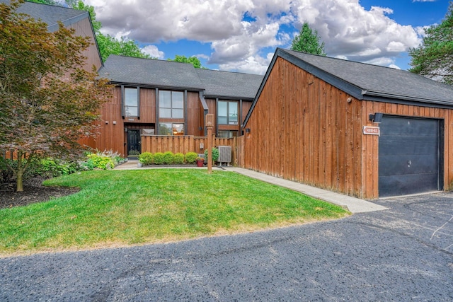 4883 Powderhorn Ln Unit 3, Westerville, OH 43081 - view of front of house with a shingled roof, a front lawn, asphalt driveway, and a detached garage
