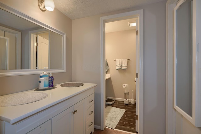4883 Powderhorn Ln Unit 3, Westerville, OH 43081 - bathroom featuring wood finished floors, vanity, and a textured ceiling