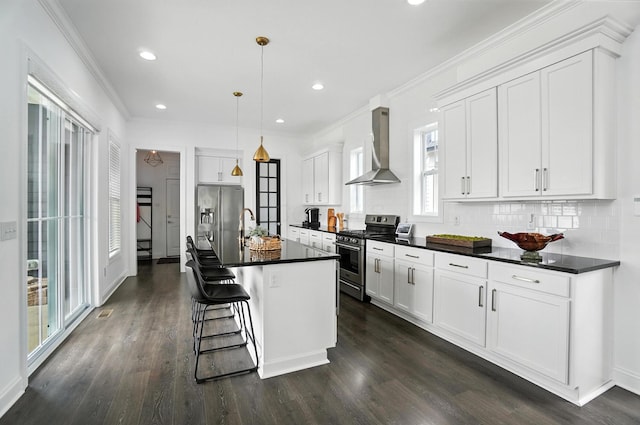 1877 Poplar Pl, Lewis Center, OH 43035 - kitchen featuring appliances with stainless steel finishes, wall chimney range hood, dark countertops, backsplash, and dark wood-style flooring