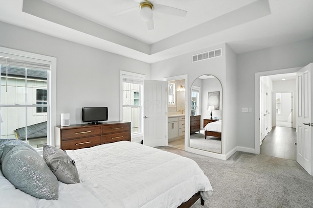 1877 Poplar Pl, Lewis Center, OH 43035 - bedroom with light carpet, multiple windows, a tray ceiling, and ensuite bathroom