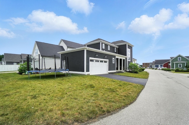 1877 Poplar Pl, Lewis Center, OH 43035 - view of front facade with a trampoline, a garage, asphalt driveway, and a residential view