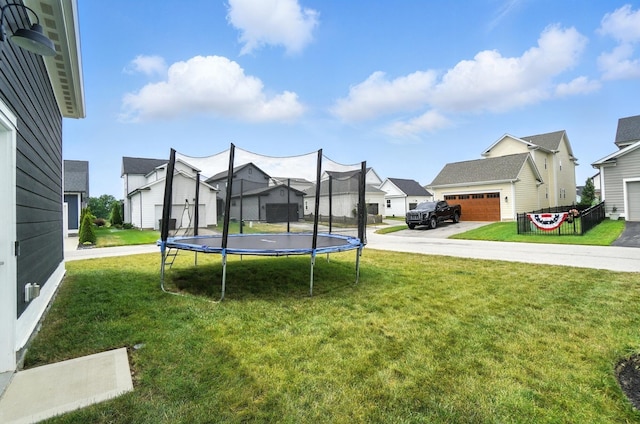 1877 Poplar Pl, Lewis Center, OH 43035 - view of grassy yard featuring a trampoline, a residential view, a garage, and a storage shed
