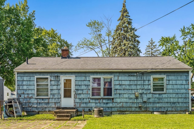 910 Pauline Ave, Columbus, OH 43224 - rear view of property featuring a chimney, a yard, and a shingled roof