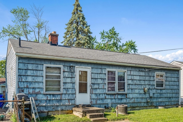 910 Pauline Ave, Columbus, OH 43224 - rear view of house with a chimney and roof with shingles