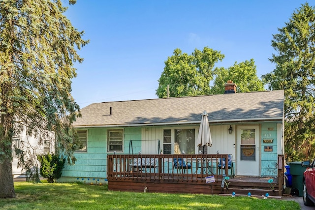 910 Pauline Ave, Columbus, OH 43224 - view of front of house featuring a front lawn, a chimney, and roof with shingles