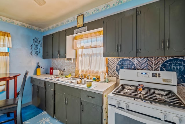 910 Pauline Ave, Columbus, OH 43224 - kitchen with white gas stove, light countertops, decorative backsplash, and gray cabinetry