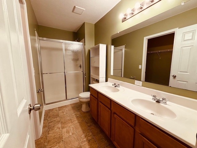 669 Gleaming Dr Unit 248, Galloway, OH 43119 - bathroom featuring a shower stall, double vanity, and a textured ceiling