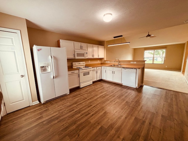 669 Gleaming Dr Unit 248, Galloway, OH 43119 - kitchen featuring white appliances, open floor plan, dark wood-type flooring, a peninsula, and a textured ceiling