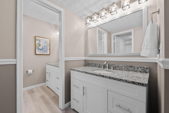 4758 Crazy Horse Ln Unit 2, Westerville, OH 43081 - bathroom with vanity, a textured ceiling, and wood finished floors