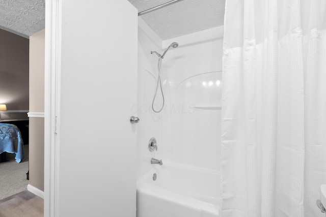 4758 Crazy Horse Ln Unit 2, Westerville, OH 43081 - bathroom featuring shower / tub combo with curtain, wood finished floors, and a textured ceiling