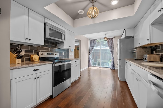 4758 Crazy Horse Ln Unit 2, Westerville, OH 43081 - kitchen featuring stainless steel appliances, a raised ceiling, white cabinets, and dark wood-style flooring