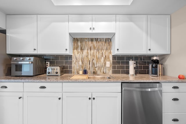 4758 Crazy Horse Ln Unit 2, Westerville, OH 43081 - kitchen with stainless steel dishwasher, white cabinets, and backsplash