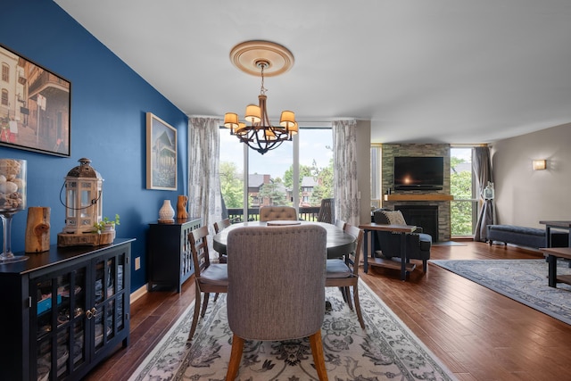 4758 Crazy Horse Ln Unit 2, Westerville, OH 43081 - dining area with a chandelier, hardwood / wood-style flooring, a large fireplace, and a wall of windows