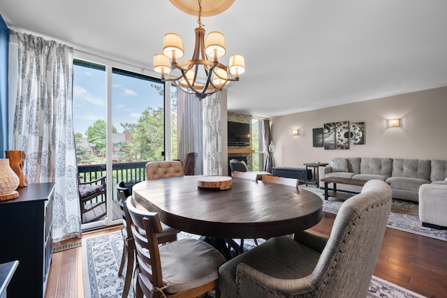 4758 Crazy Horse Ln Unit 2, Westerville, OH 43081 - dining space with a chandelier, wood-type flooring, and a large fireplace