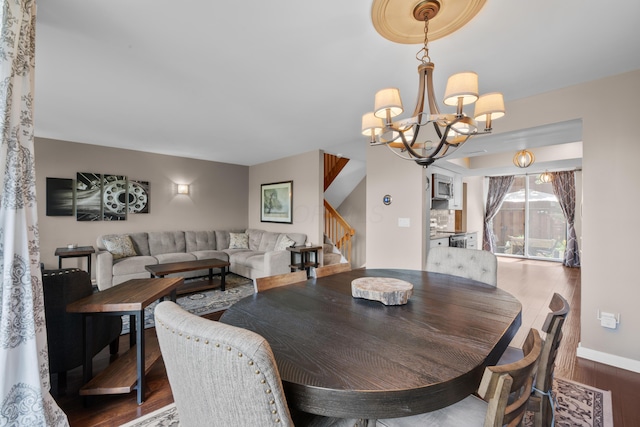 4758 Crazy Horse Ln Unit 2, Westerville, OH 43081 - dining room featuring dark wood finished floors, stairway, and a chandelier