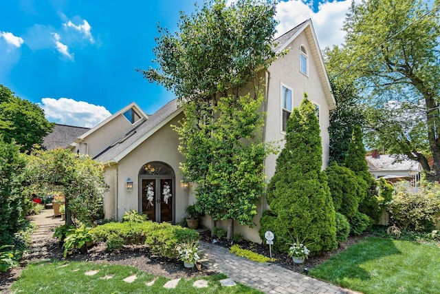 161 Jackson St, Columbus, OH 43206 - view of front of house with stucco siding, french doors, a front lawn, and a shingled roof