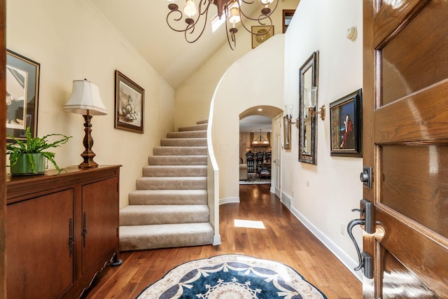 161 Jackson St, Columbus, OH 43206 - entryway with arched walkways, wood finished floors, stairway, a chandelier, and high vaulted ceiling