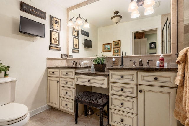 161 Jackson St, Columbus, OH 43206 - bathroom featuring double vanity, tile patterned floors, and a chandelier